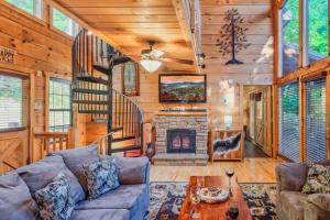 a living room with a couch and a fireplace at Goonies Cove - Spacious 4BR Cabin Arcade, Pool Table & Hot Tub! in Sevierville