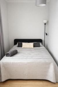 un letto in una camera da letto con copriletto bianco di Kopalniana Street a Varsavia