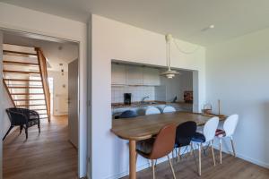 a kitchen and dining room with a wooden table and chairs at Haus Stranddüne, Whg 6 in Cuxhaven