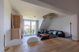 a living room with a table and a couch at Haus Stranddüne, Whg 6 in Cuxhaven
