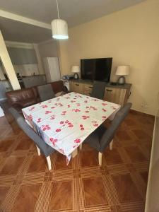 a dining room table with a table cloth on it at Home Lenda in Tarrafal