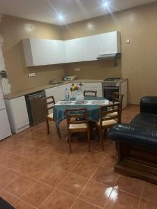 a kitchen with a table and chairs in a room at Home Lenda in Tarrafal