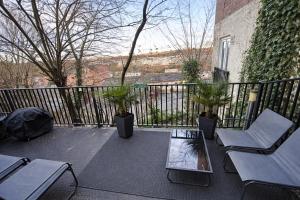 a balcony with a table and chairs and a fence at Stylish modern Cottage, Kidderminster in Kidderminster