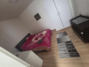 an attic room with a bed and a dresser at Relax 2 in Bukorovac