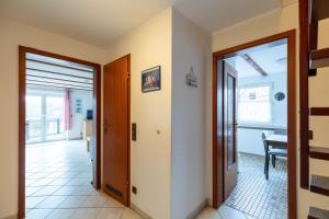 a hallway with a door leading to a living room at Am Grooten Steen, Whg 19 in Duhnen +8 photos