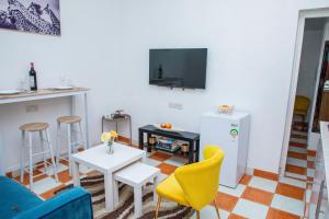 a living room with a blue couch and a table at Lion Hill Place in Nakuru