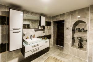 a bathroom with a sink and a shower at Birsen Hanım Konağı in Mardin +31 photos