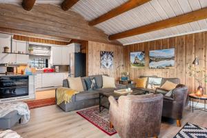 a living room with couches and a kitchen at TH616- Large ski-in out cabin in Trysilfjell for 14 guests in Trysil