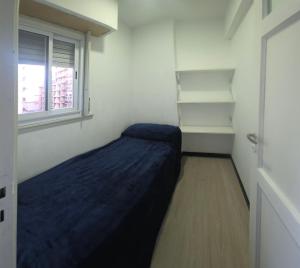 a small bedroom with a bed and a window at EdenMDQ-4 in Mar del Plata