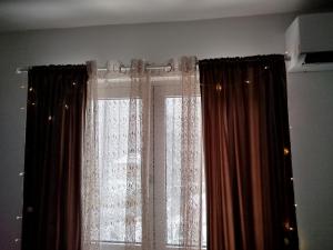 a window with curtains in a room at Vila Raj in Gornja Toplica