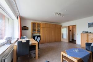 a kitchen and living room with a table and chairs at Haus Luv und Lee Wohnung 26 in Döse