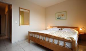 a bedroom with a bed with a wooden frame at Haus Seehund, Whg 13 in Cuxhaven