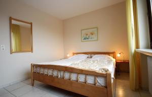 a bedroom with a bed in a room with a mirror at Haus Seehund, Whg 13 in Cuxhaven