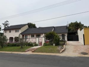 a white house with a black roof at Crest Premium in Johannesburg