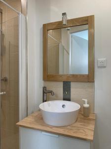 a bathroom with a white sink and a mirror at Gîte Théophile Fenal in Badonviller