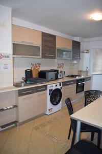 a kitchen with a washer and a dishwasher at Apartament Cathedral View Republicii RHBM in Baia Mare