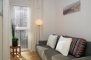a living room with a couch and a window at Haus Yachthafen, Whg 4 in Cuxhaven