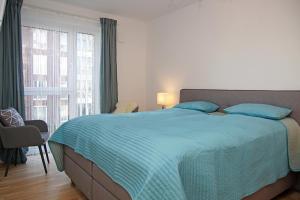 a bedroom with a bed and a large window at Haus Yachthafen, Whg 4 in Cuxhaven