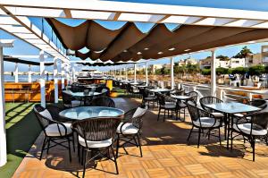 a row of tables and chairs on a deck at Five-Star Deluxe River Kruz from Aswan to Luxor 3 Nights in Aswān