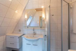 a bathroom with a sink and a shower at Seegras in Cuxhaven