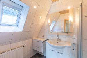 a bathroom with a sink and a mirror at Seegras in Cuxhaven +11 photos