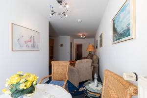 a living room with a table and chairs at Haus Elbe 1, Whg 11 in Duhnen