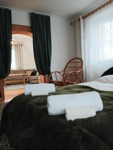 a hotel room with two beds with towels on them at Apartament Kułachówka - Sielskie wakacje na wsi, własny sad, pasieka i ogród in Leśnica