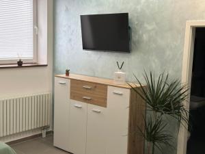 a living room with a tv on a wall at Aura Apartment 2 Herne in Herne