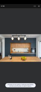 a kitchen with a table with a bowl of fruit on it at Petra in Biograd na Moru