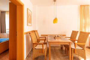 a dining room with a table and chairs at Haus Weser, Whg 2 in Döse