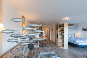a room with a glass staircase with sharks on the wall at Kurpark Residenz, App 219b in Döse