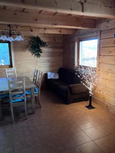 a living room with a table and a couch at Barbora chata in Nitrianske Rudno +12 photos