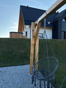 a swing in a yard with a house at Kącik Na Dolinie in Groń +69 photos