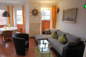 a living room with a couch and a table at Haus Elbe 1, Whg 18 in Cuxhaven