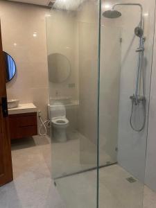 a bathroom with a glass shower with a toilet at Villa Elina 09 in Badung
