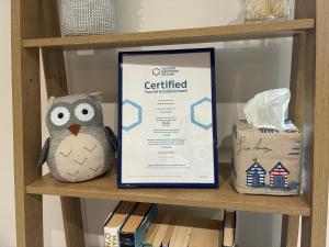 a framed sign on a shelf with a stuffed owl at Clare Escape Ballycastle - Luxury town centre apartment, walk to beach & harbour, near Giants Causeway in Ballycastle +19 photos