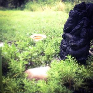 a statue of a gorilla sitting in the grass at Cosmika, eco casa de montaña in Las Calles +74 photos