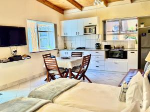 a kitchen with a table and chairs in a room at Lyn's Self Catering in Swakopmund