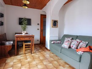 a living room with a couch and a table at Da Anny - Valdilana in Coggiola +17 photos