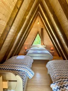 a room with four beds in a attic at Mountain Houses Emilija in Žabljak