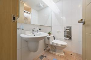 a white bathroom with a toilet and a sink at Gangnam Opal in Seoul +34 photos