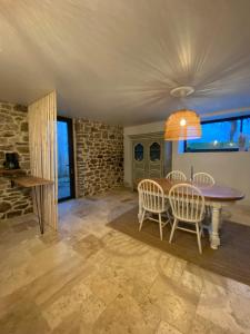 a dining room with a table and chairs at Le Logis de la Lettre in Tinténiac