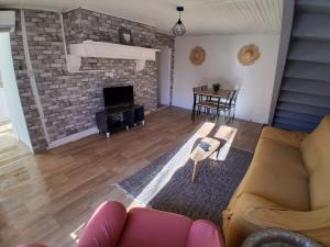 a living room with a couch and a fireplace at Maison de l'harmonie à Limoges in Limoges