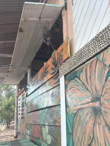 a wall with a painting of a pumpkin on it at Eco Camping Surf in Pipa +2 photos