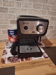 a espresso machine sitting on a table with a cup of coffee at Apartman s terasou in Oščadnica