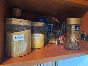 four jars of food sitting on a shelf at Apartman s terasou in Oščadnica