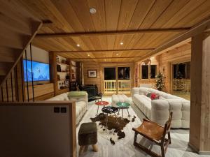 a living room with a couch and a table at Le Martagon in Vars