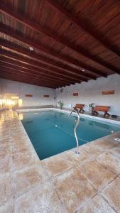 a swimming pool with a bird statue in the middle at Complejo Gran Chacha in Tanti