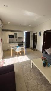 a living room with a couch and a table at Cosy 1BR with a PUBLIC POOL and WIFI in Ma‘mūrah