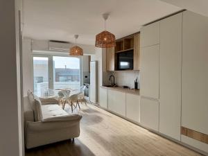 a kitchen with a couch and a table in a room at Alezzi Infiniti Resort & SPA - SUNRISE 349 in Năvodari